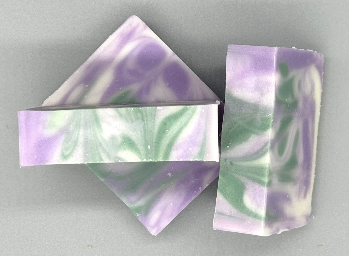 Handmade Lavender Rosemary Bar Soap – tallow-based soap scented with essential oils, purple and green swirls on white background-3 bar top view