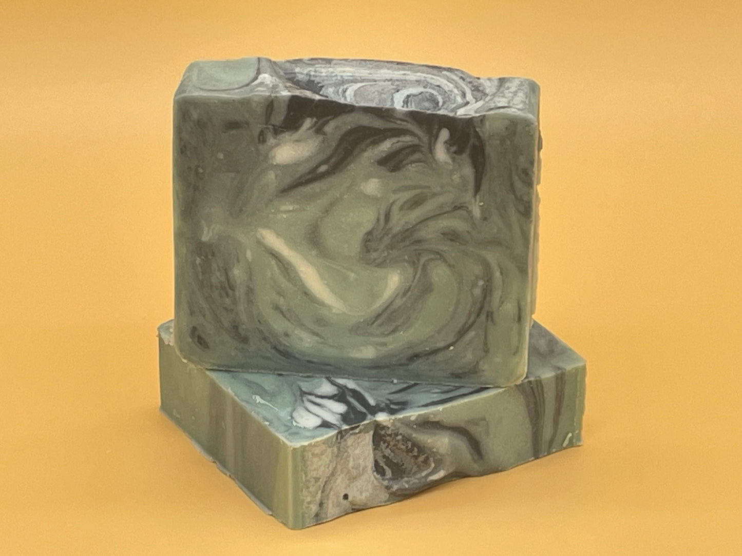 Stacked Balsam Fir handmade tallow soap bars showing natural green and black swirls, artisan soap by Talley’s Soap Co.