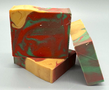Handmade tallow soap with red, green, and gold swirls, scented with apple, orange, peppermint, and clove fragrance 3 bar front view