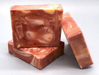 Stacked handmade tallow soaps with pink and cream swirls, bright pink grapefruit fragrance, small-batch crafted by Talley’s Soap Co