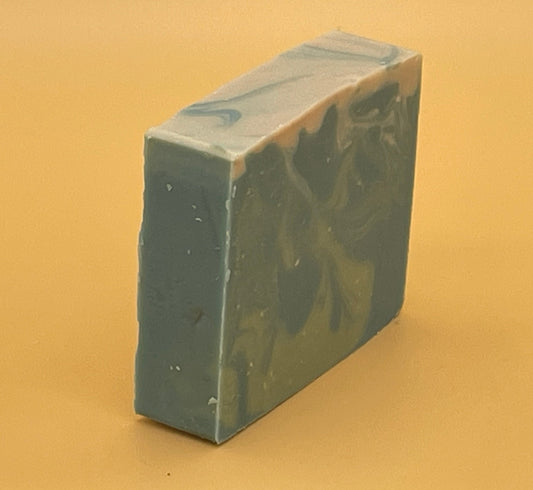 Angled view of The Seafarer handmade tallow soap showing blue and cream marbling