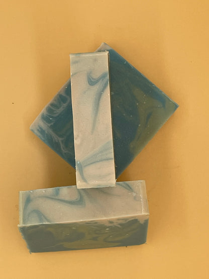 Top-down view of three Seafarer handmade tallow soap bars arranged on yellow background